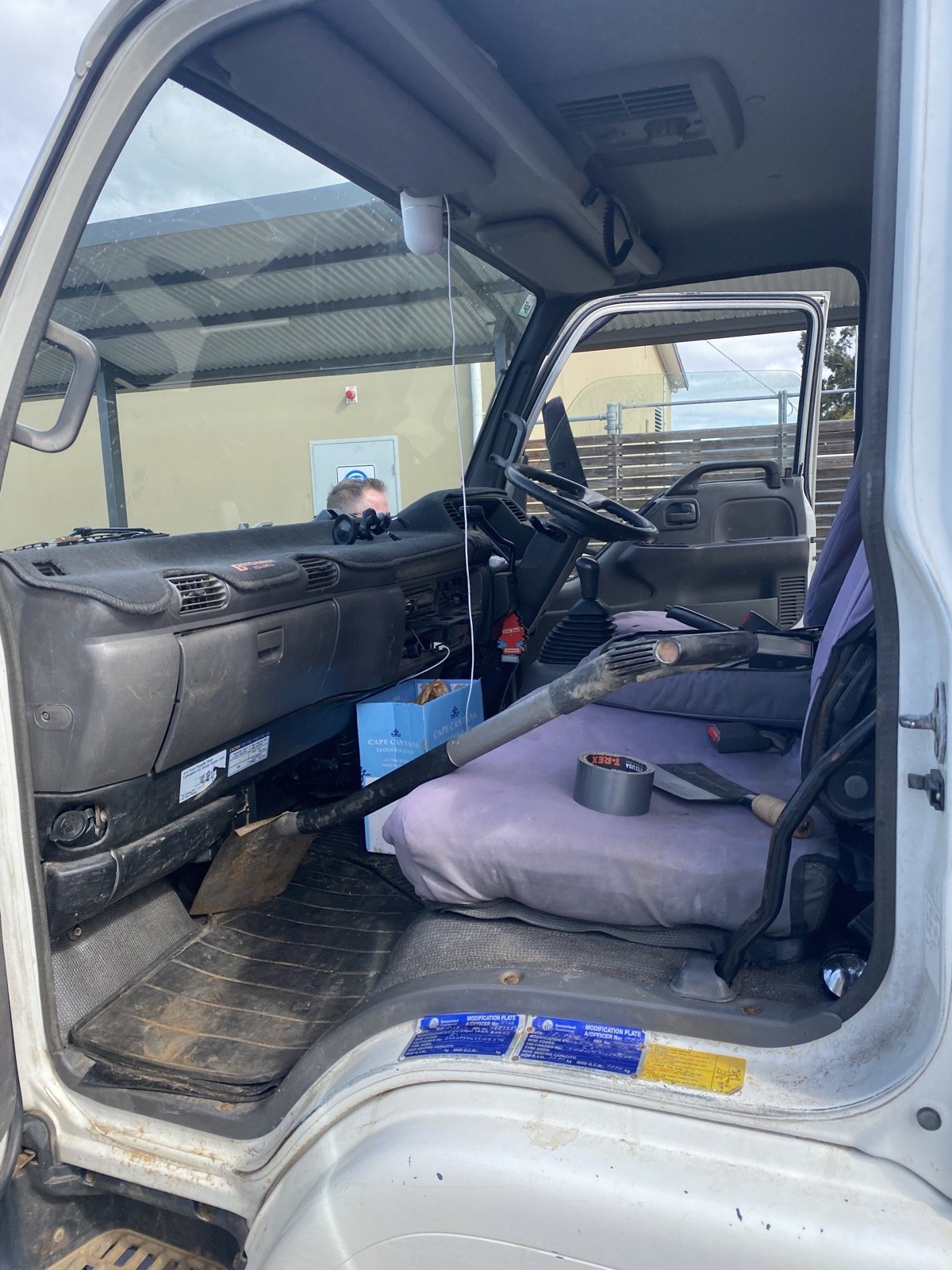Inside Shan's Isuzu truck cab